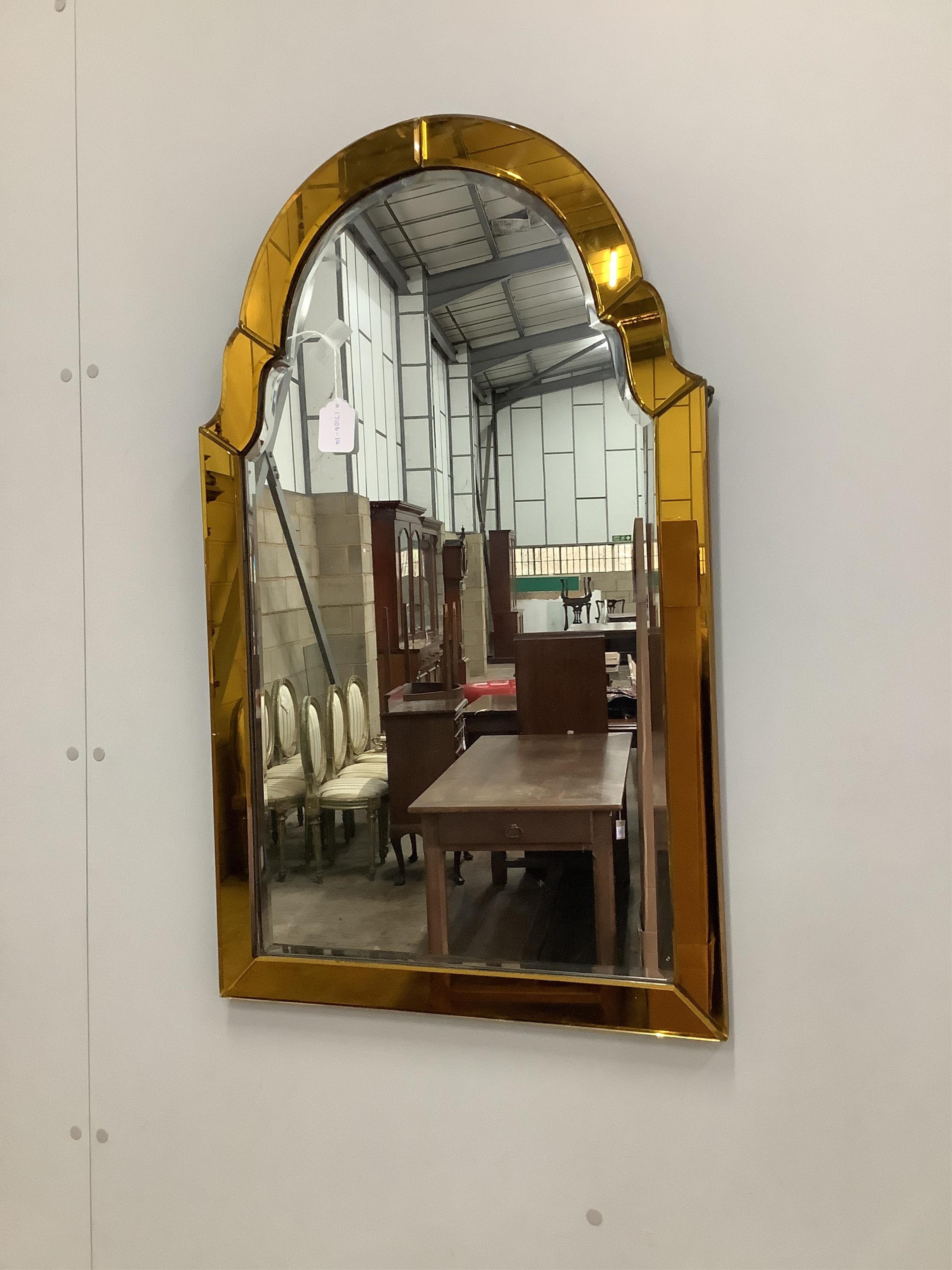 An Art Deco style amber and clear glass wall mirror, width 54cm, height 89cm. Condition - fair